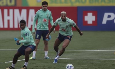 Brazil's Endrick, left, teammate Joelinton, right, battle for the ball during a training session ahead of a 2026 World Cup qualifier soccer match against Argentina, in Teresopolis, Brazil, Monday, Nov. 20, 2023. (AP Photo/Bruna Prado)