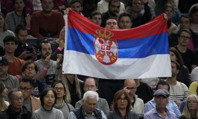 A man shows a Serbian flag during the final match between Serbia's Novak Djokovic and Bulgaria's Grigor Dimitrov at the Paris Masters tennis tournament in Paris, Sunday, Nov. 5, 2023. (AP Photo/Michel Euler)