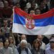 A man shows a Serbian flag during the final match between Serbia's Novak Djokovic and Bulgaria's Grigor Dimitrov at the Paris Masters tennis tournament in Paris, Sunday, Nov. 5, 2023. (AP Photo/Michel Euler)