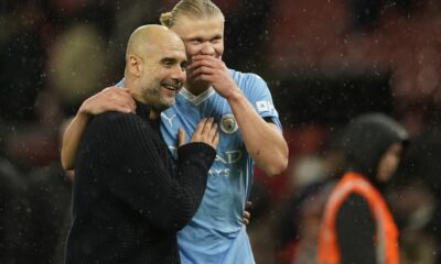 Manchester City's head coach Pep Guardiola talks to Manchester City's Erling Haaland after the English Premier League soccer match between Manchester United and Manchester City at Old Trafford stadium in Manchester, England, Sunday, Oct. 29, 2023. (AP Photo/Dave Thompson)