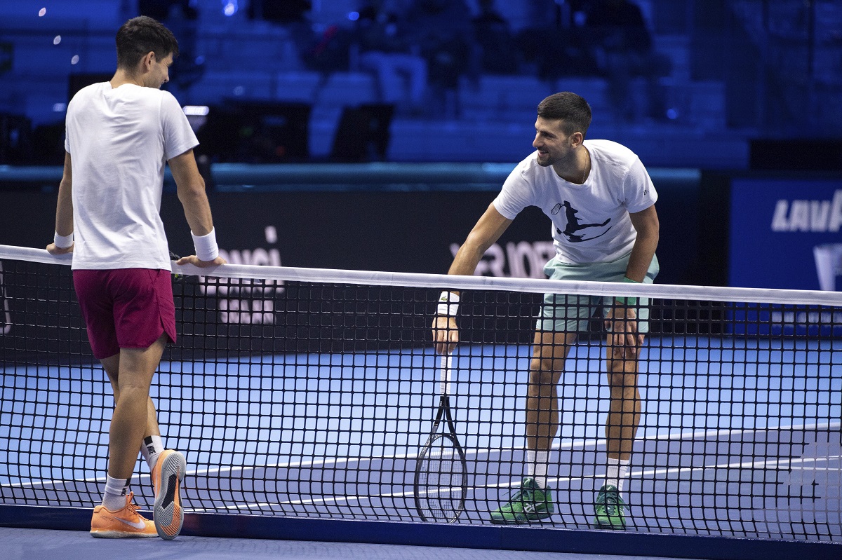 Spain's Carlos Alcaraz, left, and Serbia's Novak Djokovic during a training session ahead of the ATP Finals, in Turin, Italy, Friday, Nov. 10, 2023. (Marco Alpozzi/LaPresse via AP)
