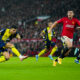 Bournemouth's Dominic Solanke, left, kicks the ball during the English Premier League soccer match between Manchester United and Bournemouth at the Old Trafford stadium in Manchester, England, Saturday, Dec. 9, 2023. (AP Photo/Jon Super)