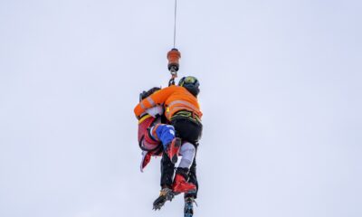 Austria's Marco Schwarz, left, is airlifted after crashing during an alpine ski, men's World Cup downhill race, in Bormio, Italy, Thursday, Dec. 28, 2023. Schwarz appeared to hurt his right knee in a left turn before getting thrown off the course halfway through his run. He was taken off the hill by a helicopter. (AP Photo/Giovanni Zenoni)