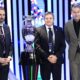 The head coaches of England Gareth Southgate, right, Serbia Dragan Stojkovic, center, and Denmark Kasper Hjulmand, left, pose next to the trophy after the draw for the UEFA Euro 2024 soccer tournament finals in Hamburg, Germany, Saturday, Dec. 2, 2023. (AP Photo/Martin Meissner)