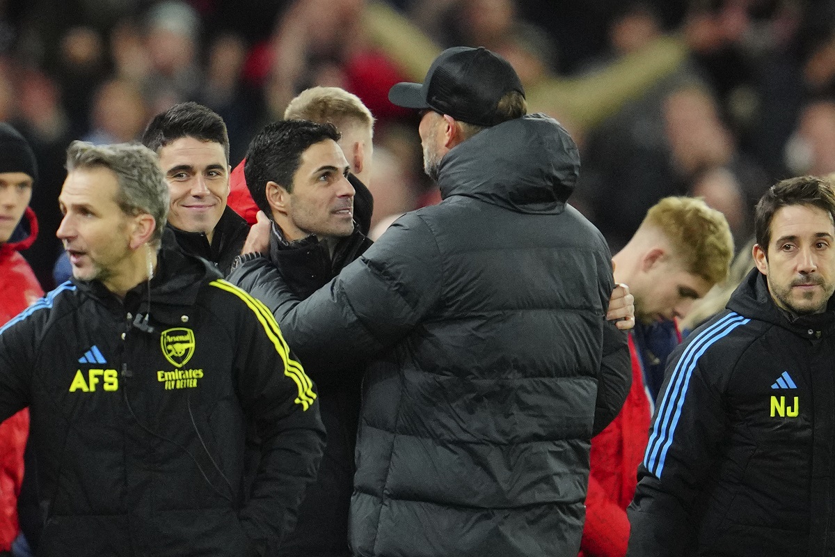 Liverpool's manager Jurgen Klopp, right, hugs Arsenal's manager Mikel Arteta at the end of the English Premier League soccer match between Liverpool and Arsenal at Anfield stadium in Liverpool, England, Saturday, Dec. 23, 2023. (AP Photo/Jon Super)