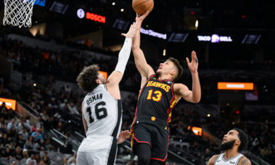 Atlanta Hawks' Bogdan Bogdanovic (13) goes to the basket against San Antonio Spurs' Cedi Osman during the first half of an NBA basketball game Thursday, Nov. 30, 2023, in San Antonio. (AP Photo/Darren Abate)