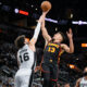 Atlanta Hawks' Bogdan Bogdanovic (13) goes to the basket against San Antonio Spurs' Cedi Osman during the first half of an NBA basketball game Thursday, Nov. 30, 2023, in San Antonio. (AP Photo/Darren Abate)
