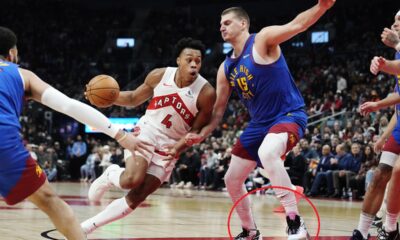 Toronto Raptors' Scottie Barnes (4) drives past Denver Nuggets' Nikola Jokic (15) during the first half of an NBA basketball game in Toronto on Wednesday, Dec. 20, 2023. (Frank Gunn/The Canadian Press via AP)