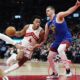 Toronto Raptors' Scottie Barnes (4) drives past Denver Nuggets' Nikola Jokic (15) during the first half of an NBA basketball game in Toronto on Wednesday, Dec. 20, 2023. (Frank Gunn/The Canadian Press via AP)