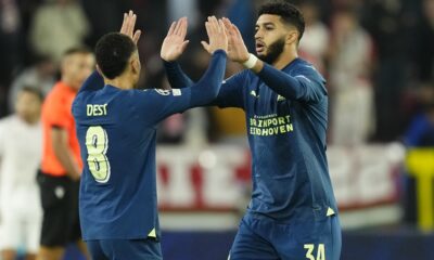 PSV's Ismael Saibari celebrates with his teammate Sergino Dest after scoring his side's first goal during the Champions League Group B soccer match between Sevilla and PSV at the Ramon Sanchez-Pizjuan stadium in Seville, Spain, Wednesday, Nov.29, 2023. (AP Photo/Jose Breton)