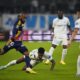 Lyon's Alexandre Lacazette, left, and Marseille's Michael Murillo, centre, challenge for the ball during the French League One soccer match between Olympique de Marseille and Lyon at the Velodrome Stadium in Marseille, France, Wednesday, Dec. 6, 2023. (AP Photo/Daniel Cole)
