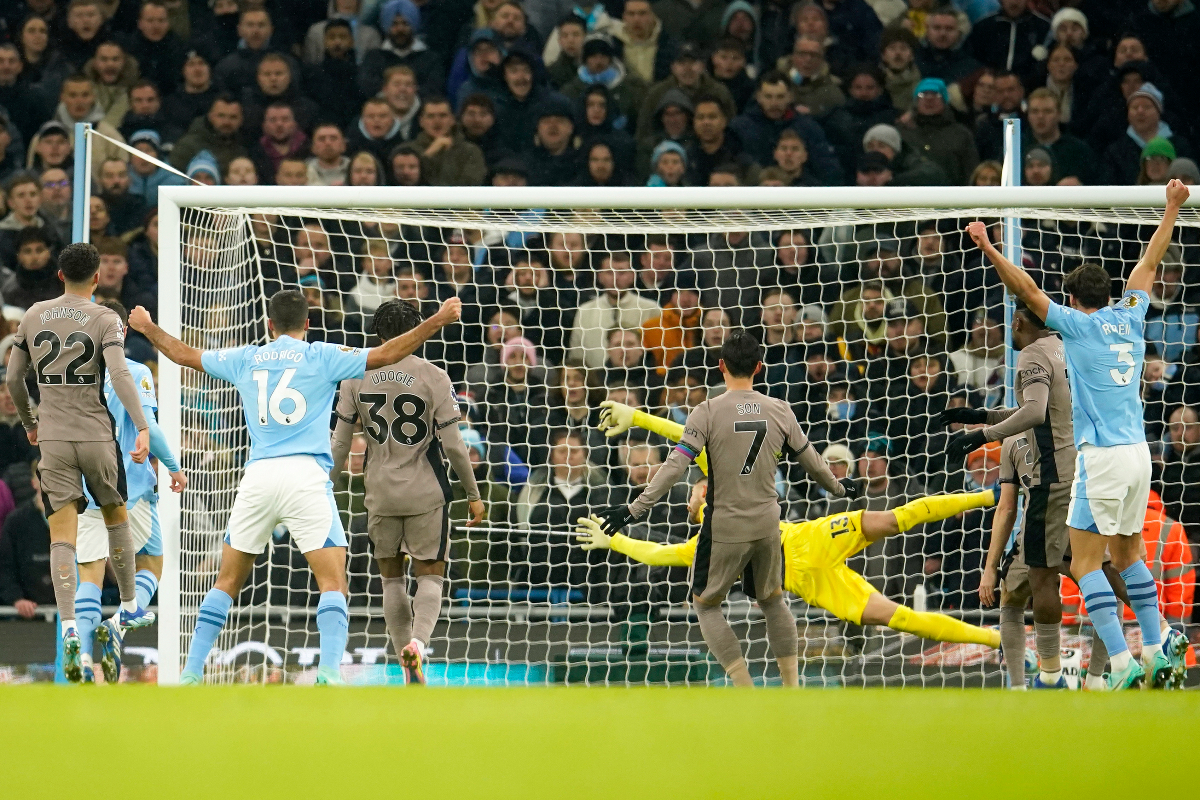 Tottenham's Son Heung-min, center, scores an own goal to tie the match 1-1 during the English Premier League soccer match between Manchester City and Tottenham Hotspur at Etihad stadium in Manchester, England, Sunday, Dec. 3, 2023. (AP Photo/Dave Thompson)