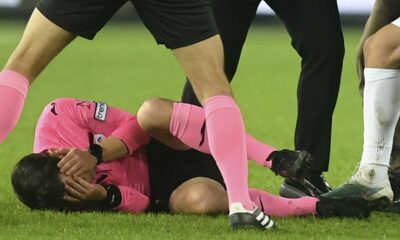 Referee Halil Umut Meler holds his face as he lies on the ground after being punched by MKE Ankaragucu president Faruk Koca, center right, at the end of the Turkish Super Lig soccer match between MKE Ankaragucu and Caykur Rizespor in Ankara, Monday, Dec. 11, 2023. The Turkish Football Federation has suspended all league games in the country after a club president punched the referee in the face at the end of a top-flight match. Koca was arrested Tuesday, Dec. 12, 2023, along with two other people on charges of injuring a public official following questioning by prosecutors. (Abdurrahman Antakyali/Depo Photos via AP)