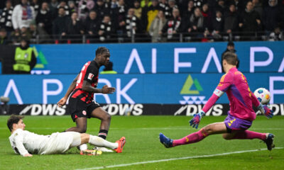 Frankfurt's Eric Junior Dina Ebimbe, center, scores his side's fourth goal of the game past Munich goalkeeper Manuel Neuer during the German Bundesliga soccer match between Eintracht Frankfurt and Bayern Munich at Deutsche Bank Park in Frankfurt, Germany, Saturday, Dec. 9, 2023. (Arne Dedert/dpa via AP)