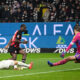 Frankfurt's Eric Junior Dina Ebimbe, center, scores his side's fourth goal of the game past Munich goalkeeper Manuel Neuer during the German Bundesliga soccer match between Eintracht Frankfurt and Bayern Munich at Deutsche Bank Park in Frankfurt, Germany, Saturday, Dec. 9, 2023. (Arne Dedert/dpa via AP)