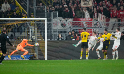 Mainz's Sepp van den Berg, fourth right, scores his sides first goal during the German Bundesliga soccer match between Borussia Dortmund and 1. FSV Mainz 05 at the Signal-Iduna Park in Dortmund, Germany, Tuesday, Dec. 19, 2023. (AP Photo/Martin Meissner)