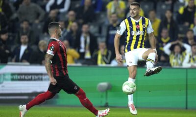Fenerbahce's Dusan Tadic, right, plays the ball next to Spartak Trnava's Kristisn Kostrna during the Europa Conference League group H soccer match between Fenerbahce and Spartak Trnava at Sukru Saracoglu stadium in Istanbul, Turkey, Thursday, Dec. 14, 2023. (AP Photo/Francisco Seco)