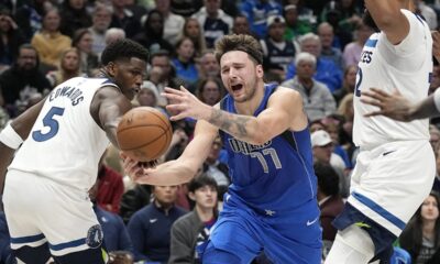 Dallas Mavericks guard Luka Doncic (77) is fouled by Minnesota Timberwolves guard Anthony Edwards (5) during the first half of an NBA basketball game in Dallas, Thursday, Dec. 14, 2023. (AP Photo/LM Otero)