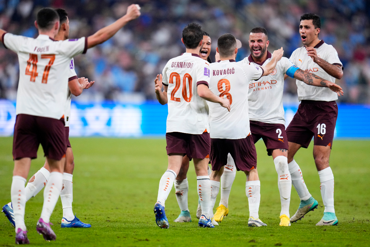 Manchester City's Mateo Kovacic celebrates with teammate Kyle Walker, 2nd right, after scoring his side's second goal during the Soccer Club World Cup semifinal soccer match between Urawa Reds and Manchester City FC at King Abdullah Sports City Stadium in Jeddah, Saudi Arabia, Tuesday, Dec. 19, 2023. (AP Photo/Manu Fernandez)