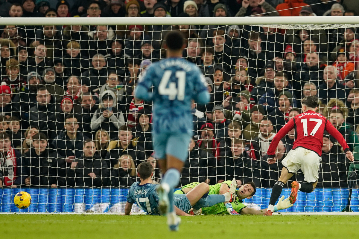 Manchester United's Alejandro Garnacho, right, scores his side's opening goal during the English Premier League soccer match between Manchester United and Aston Villa at the Old Trafford stadium in Manchester, England, Tuesday, Dec. 26, 2023. (AP Photo/Dave Thompson)