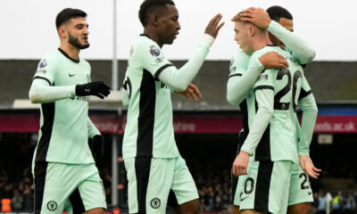 Chelsea's Cole Palmer, right, celebrates with teammates after scoring his sides first goal during the English Premier League soccer match between Luton Town and Chelsea, at Kenilworth Road, in Luton, England, Saturday, Dec. 30, 2023. (AP Photo/Alastair Grant)