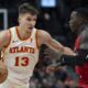 Atlanta Hawks Bogdan Bogdanović (13) drives past Toronto Raptors guard Dennis Schröder during the second half of an NBA basketball game in Toronto, Wednesday, Dec. 13, 2023. (Frank Gunn/The Canadian Press via AP)