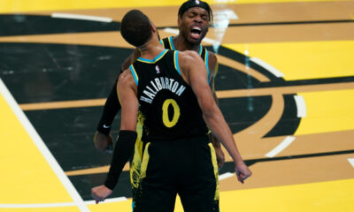 Indiana Pacers' Tyrese Haliburton (0) and Buddy Hield, right, celebrate during the second half of an NBA basketball In-Season Tournament game against the Boston Celtics, Monday, Dec. 4, 2023, in Indianapolis. (AP Photo/Darron Cummings)