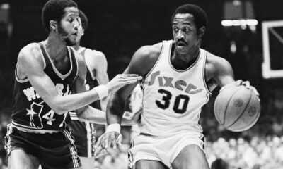 FILE - Golden State Warriors Jamaal Wilkes (41) tries to keep 76ers forward George McGinnis (30) from getting closer to the basket during the first half of NBA game on Tuesday, Nov. 25, 1975 in Philadelphia. McGinnis, a Hall of Fame forward who was a two-time ABA champion and three-time All-Star in the NBA and ABA, died Thursday, Dec. 14, 2023 He was 73. (AP Photo/Rusty Kennedy, File)