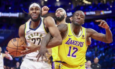 Indiana Pacers forward Isaiah Jackson (22) grabs a rebound next to Los Angeles Lakers forwards Anthony Davis and Taurean Prince (12) during the first half of the championship game in the NBA basketball In-Season Tournament on Saturday, Dec. 9, 2023, in Las Vegas. (AP Photo/Ian Maule)