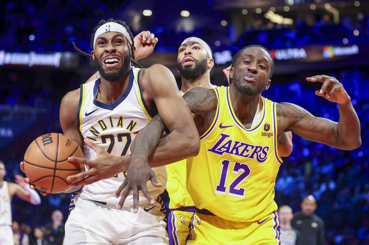 Indiana Pacers forward Isaiah Jackson (22) grabs a rebound next to Los Angeles Lakers forwards Anthony Davis and Taurean Prince (12) during the first half of the championship game in the NBA basketball In-Season Tournament on Saturday, Dec. 9, 2023, in Las Vegas. (AP Photo/Ian Maule)
