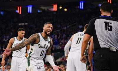 Milwaukee Bucks guard Damian Lillard (0) argues a call with referee Zach Zarba (15) during the first half of an NBA basketball game against the New York Knicks in New York, Saturday, Dec. 23, 2023. (AP Photo/Peter K. Afriyie)