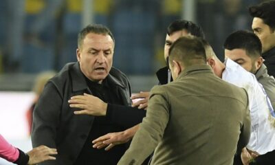 An unidentified man kicks referee Halil Umut Meler who is lying on the ground after he was also punched by MKE Ankaragucu president Faruk Koca, left, at the end of the Turkish Super Lig soccer match between MKE Ankaragucu and Caykur Rizespor in Ankara, Monday, Dec. 11, 2023. The Turkish Football Federation has suspended all league games in the country after a club president punched the referee in the face at the end of a top-flight match. Koca was arrested Tuesday, Dec. 12, 2023, along with two other people on charges of injuring a public official following questioning by prosecutors. (Abdurrahman Antakyali/Depo Photos via AP)