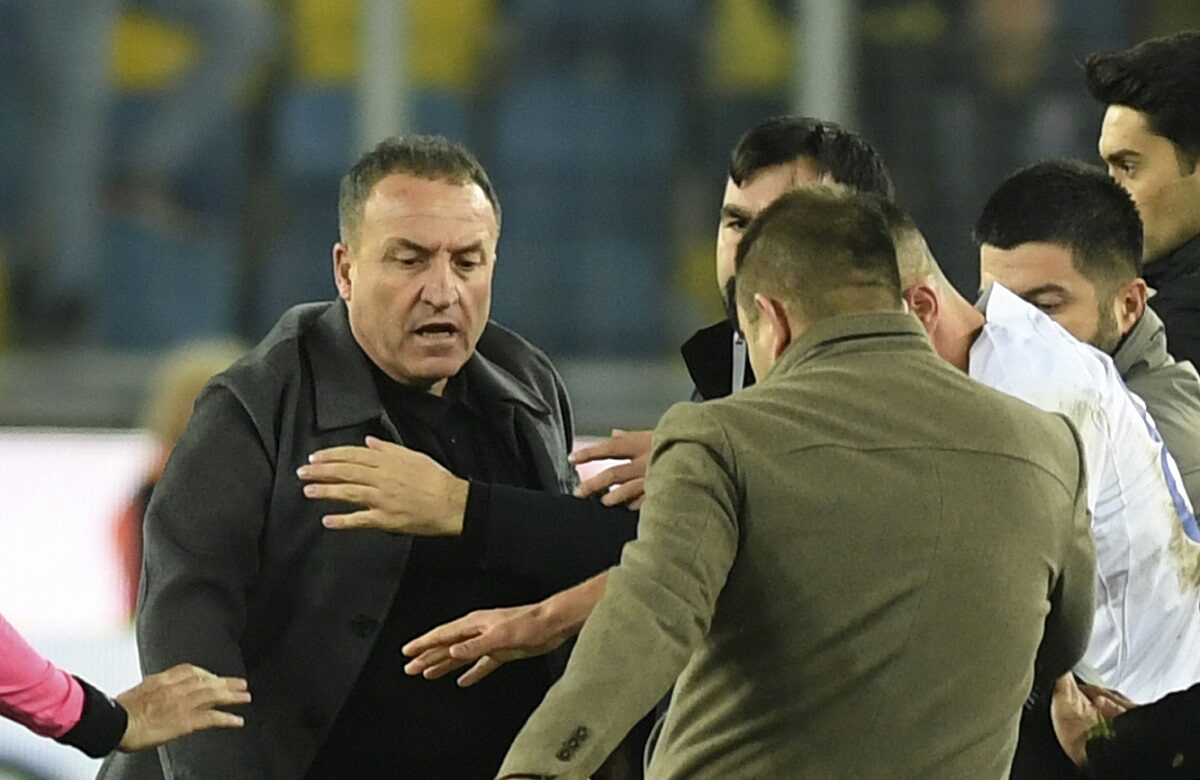 An unidentified man kicks referee Halil Umut Meler who is lying on the ground after he was also punched by MKE Ankaragucu president Faruk Koca, left, at the end of the Turkish Super Lig soccer match between MKE Ankaragucu and Caykur Rizespor in Ankara, Monday, Dec. 11, 2023. The Turkish Football Federation has suspended all league games in the country after a club president punched the referee in the face at the end of a top-flight match. Koca was arrested Tuesday, Dec. 12, 2023, along with two other people on charges of injuring a public official following questioning by prosecutors. (Abdurrahman Antakyali/Depo Photos via AP)