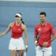 Novak Djokovic and Olga Danilovic of Serbia laugh on court during their mixed doubles match against Qinwen Zheng and Zhizhen Zhang of China during the United Cup tennis tournament in Perth, Australia, Sunday, Dec. 31, 2023. (AP Photo/Trevor Collens)
