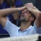 Novak Djokovic of Serbia places a bag of ice on his head during a break in his quarterfinal against Taylor Fritz of the U.S. at the Australian Open tennis championships at Melbourne Park, Melbourne, Australia, Tuesday, Jan. 23, 2024. (AP Photo/Asanka Brendon Ratnayake)