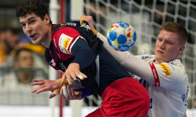 Island's Ymir Orn Gislason , right, and Croatia's Luka Lovre Klarica challenge during the Handball European Championship main round match between Croatia and Iceland in Cologne, Germany, Monday, Jan. 22, 2024. (AP Photo/Martin Meissner)