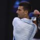 Novak Djokovic of Serbia plays a backhand return to Tomas Martin Etcheverry of Argentina during their third round match at the Australian Open tennis championships at Melbourne Park, Melbourne, Australia, Friday, Jan. 19, 2024. (AP Photo/Asanka Brendon Ratnayake)