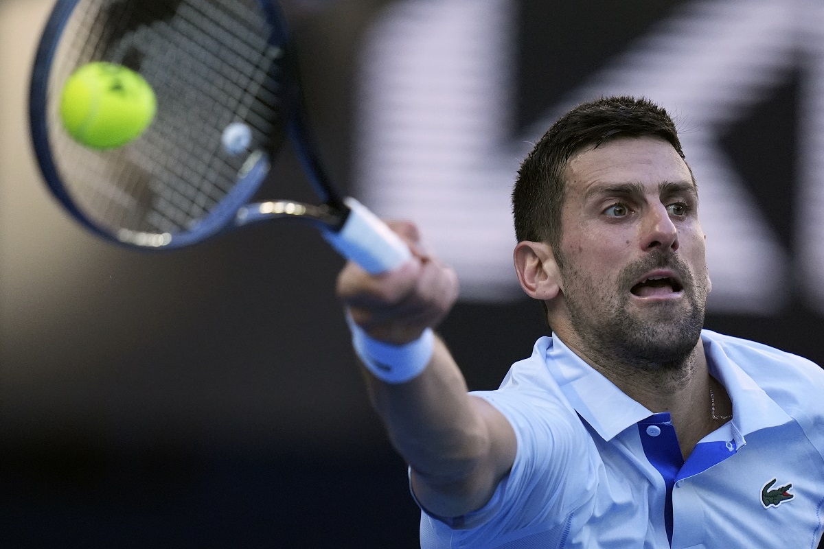 Novak Djokovic of Serbia plays a forehand return to Taylor Fritz of the U.S. during their quarterfinal match at the Australian Open tennis championships at Melbourne Park, Melbourne, Australia, Tuesday, Jan. 23, 2024. (AP Photo/Andy Wong)