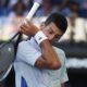 Novak Djokovic of Serbia wipes the sweat from his face during his quarterfinal against Taylor Fritz of the U.S. at the Australian Open tennis championships at Melbourne Park, Melbourne, Australia, Tuesday, Jan. 23, 2024. (AP Photo/Asanka Brendon Ratnayake)