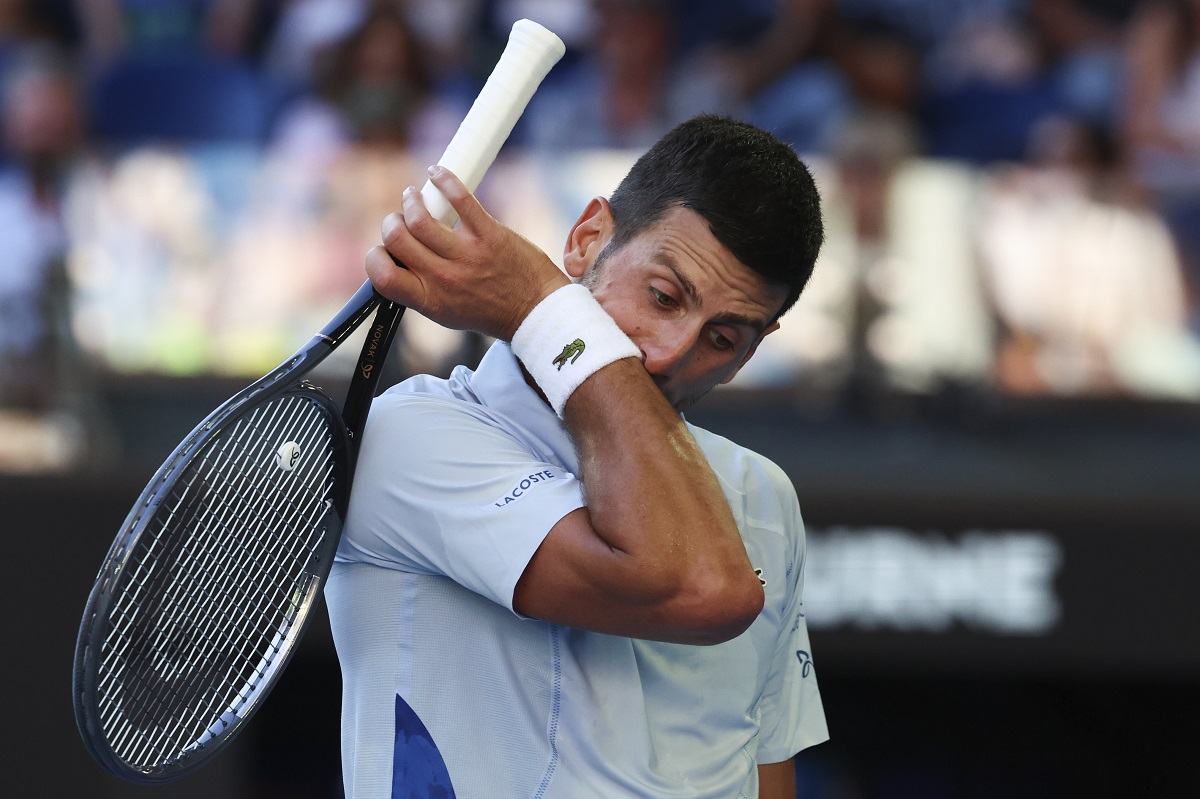Novak Djokovic of Serbia wipes the sweat from his face during his quarterfinal against Taylor Fritz of the U.S. at the Australian Open tennis championships at Melbourne Park, Melbourne, Australia, Tuesday, Jan. 23, 2024. (AP Photo/Asanka Brendon Ratnayake)
