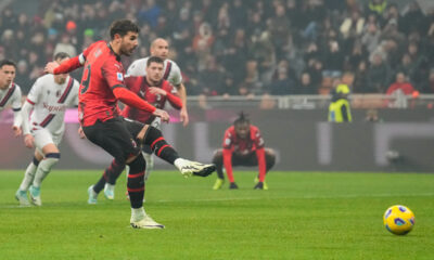 AC Milan's Theo Hernandez, front, fails to score from the penalty spot during the Serie A soccer match between AC Milan and Bologna at the San Siro stadium, in Milan, Italy, Saturday, Jan. 27, 2024. (AP Photo/Antonio Calanni)