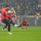 AC Milan's Theo Hernandez, front, fails to score from the penalty spot during the Serie A soccer match between AC Milan and Bologna at the San Siro stadium, in Milan, Italy, Saturday, Jan. 27, 2024. (AP Photo/Antonio Calanni)