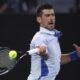 Novak Djokovic of Serbia plays a forehand return to Tomas Martin Etcheverry of Argentina during their third round match at the Australian Open tennis championships at Melbourne Park, Melbourne, Australia, Friday, Jan. 19, 2024. (AP Photo/Asanka Brendon Ratnayake)