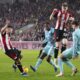 Brentford's Neal Maupay, left, scores his side's first goal of the game during the English FA Cup, third round soccer match between Brentford and Wolverhampton Wanderers, at the Gtech Community Stadium, in London, Friday, Jan. 5, 2024. (John Walton/PA via AP)