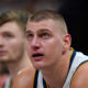 Denver Nuggets center Nikola Jokic looks sits on the bench during the second half of the team's NBA basketball game against the Utah Jazz on Wednesday, Jan. 10, 2024, in Salt Lake City. (AP Photo/Rick Bowmer)