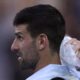 Novak Djokovic of Serbia places a bag of ice on his head during a break in his quarterfinal against Taylor Fritz of the U.S. at the Australian Open tennis championships at Melbourne Park, Melbourne, Australia, Tuesday, Jan. 23, 2024. (AP Photo/Andy Wong)