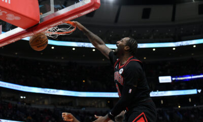 Chicago Bulls' Andre Drummond, top, dunks during the second half of an NBA basketball game against the Philadelphia 76ers, Saturday, Dec. 30, 2023, in Chicago. (AP Photo/Paul Beaty)