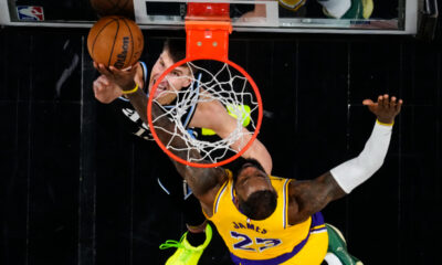 Atlanta Hawks guard Bogdan Bogdanovic (13) has his shot blocked by Los Angeles Lakers forward LeBron James (23) in the second half of an NBA basketball game Tuesday, Jan. 30, 2024, in Atlanta. (AP Photo/John Bazemore)