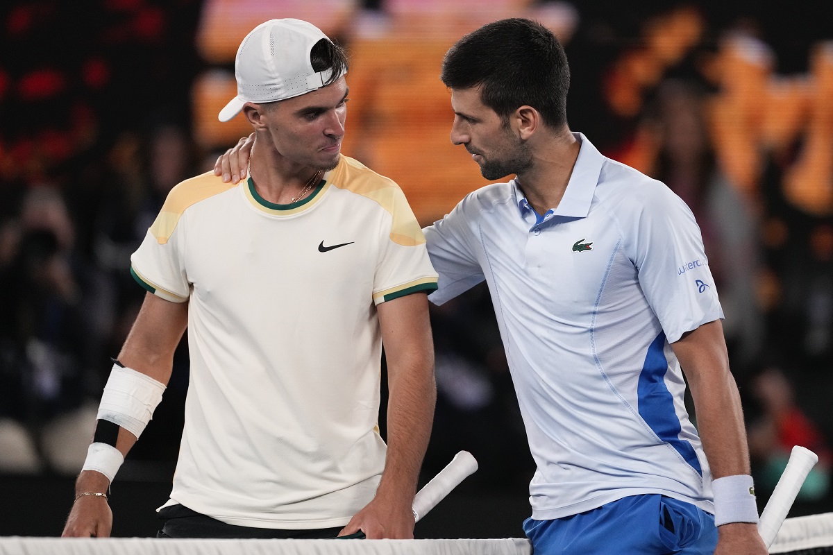Serbia's Novak Djokovic, right, is congratulated by Croatia's Dino Prizmic following their first round match at the Australian Open tennis championships at Melbourne Park, Melbourne, Australia, Sunday, Jan. 14, 2024. (AP Photo/Alessandra Tarantino)