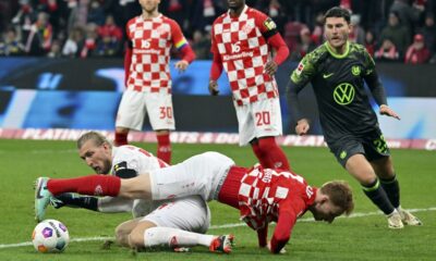 Mainz goalkeeper Robin Zentner drops his teammate Sepp van den Berg during the Bundesliga soccer match between VfL Wolfsburg and FSV Mainz at MEWA Arena stadium in Mainz, Germany, Saturday Jan. 13, 2024. (Torsten Silz/dpa via AP)